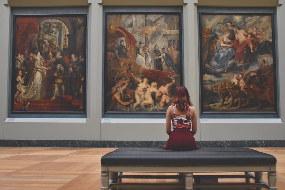 sitting in front of art
